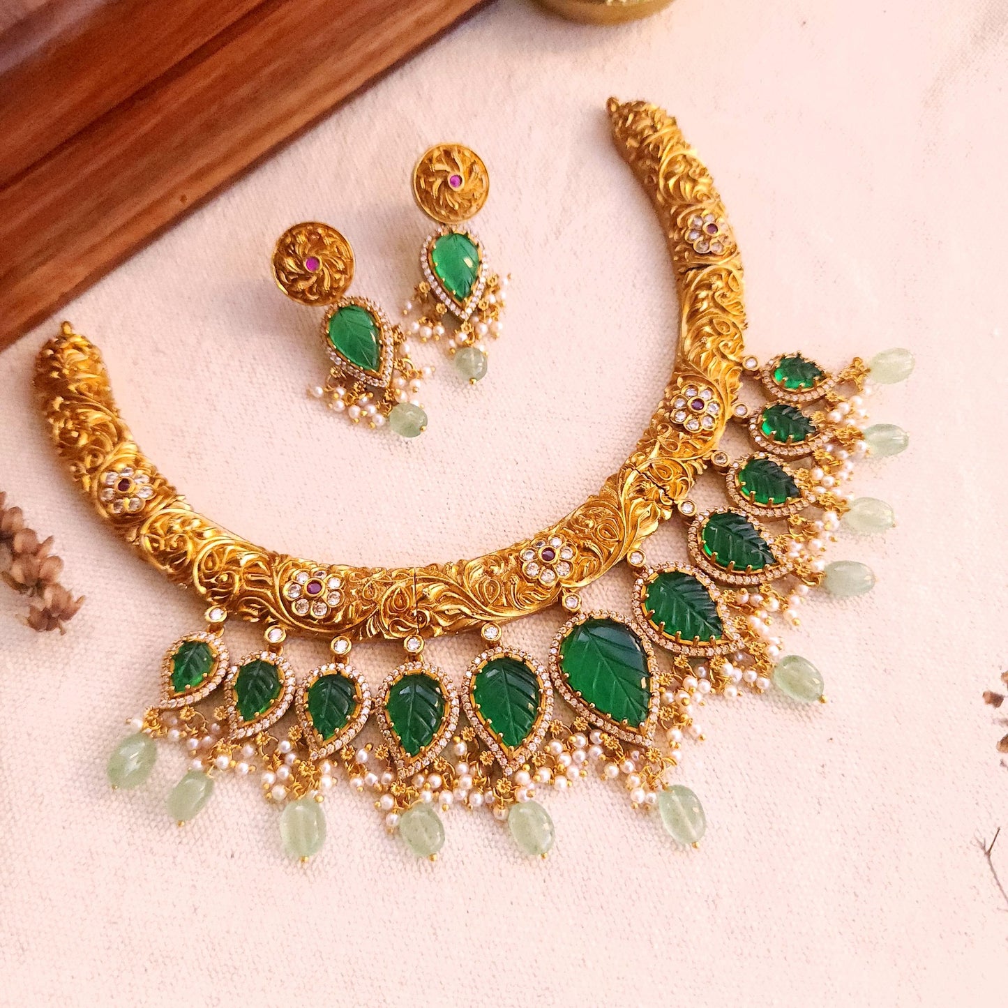 Nakshi finish hasli with carved green stones