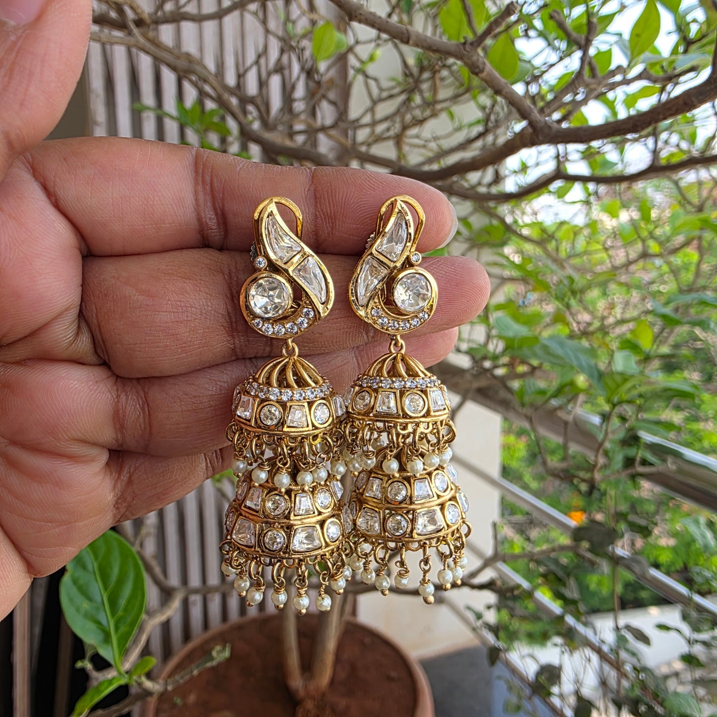 Moissanite polki double layered jumkha with peacock motif.