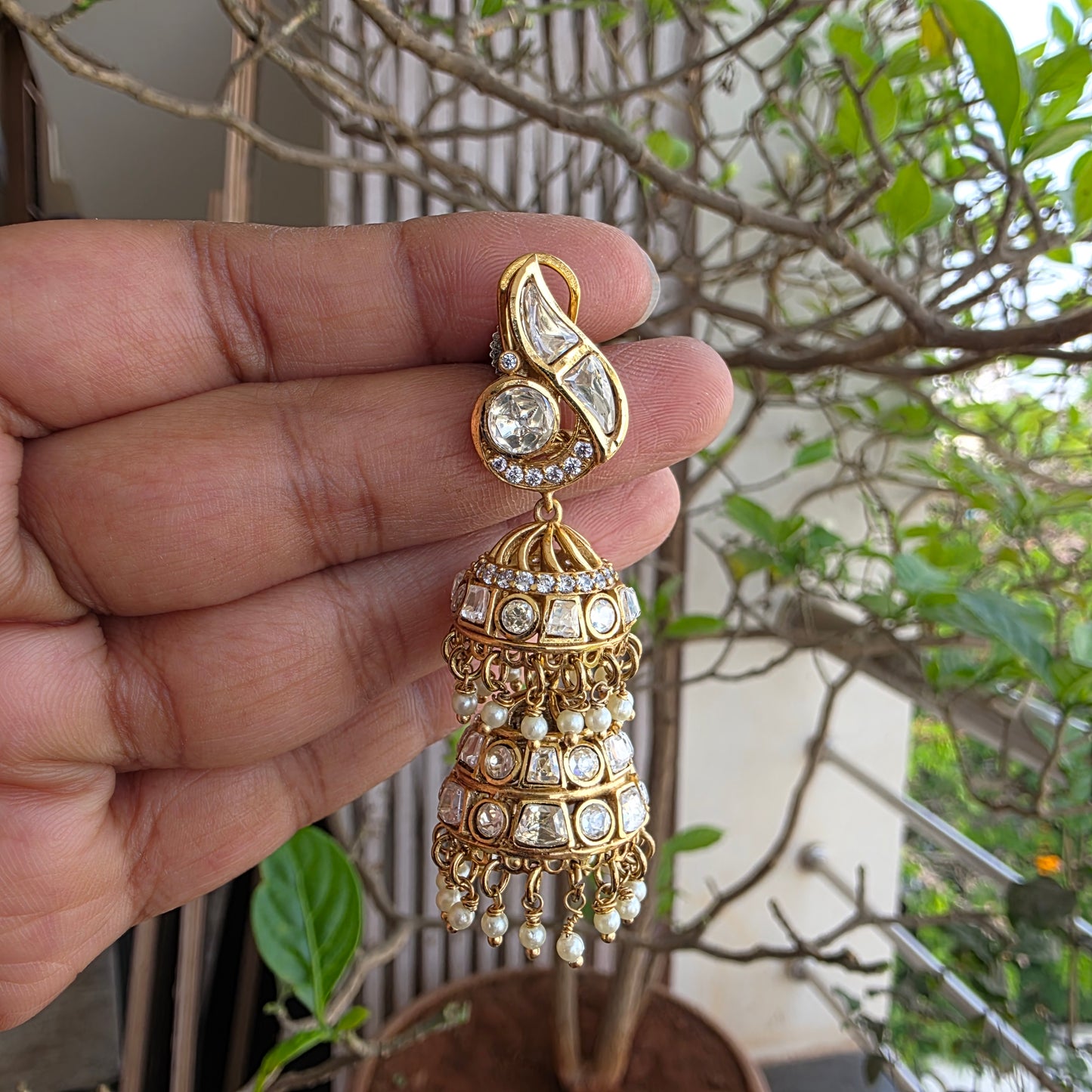 Moissanite polki double layered jumkha with peacock motif.