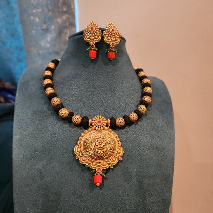 Amrutha-Black thread neckset with nakshi ball and coral bead