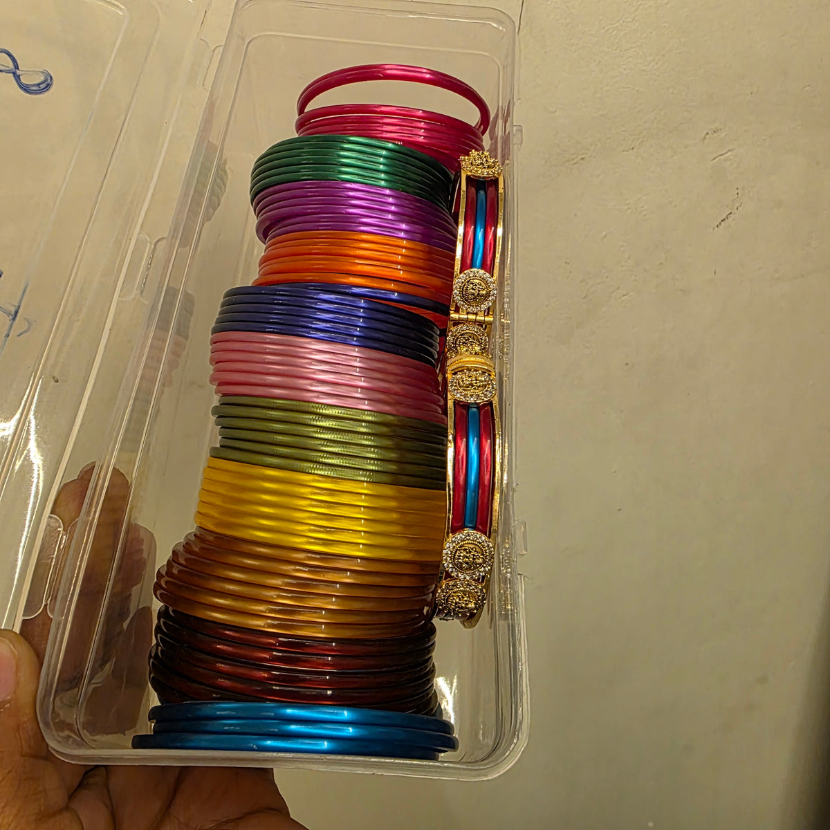 Jaya- antique bangle frame with 12 colors of changeable plastic bangles.